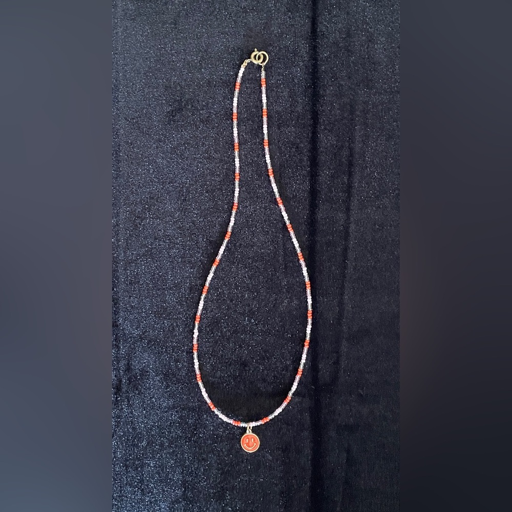 Handmade beaded necklace with smiley face charm